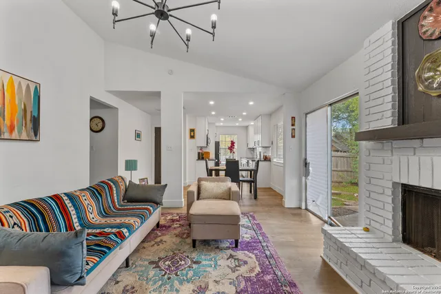 a living room with furniture fireplace and a rug