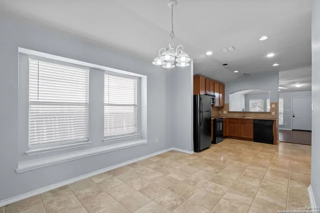 a view of a kitchen with a sink and chandelier