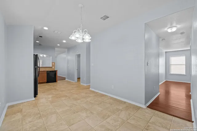 a view of a kitchen with a sink and a chandelier