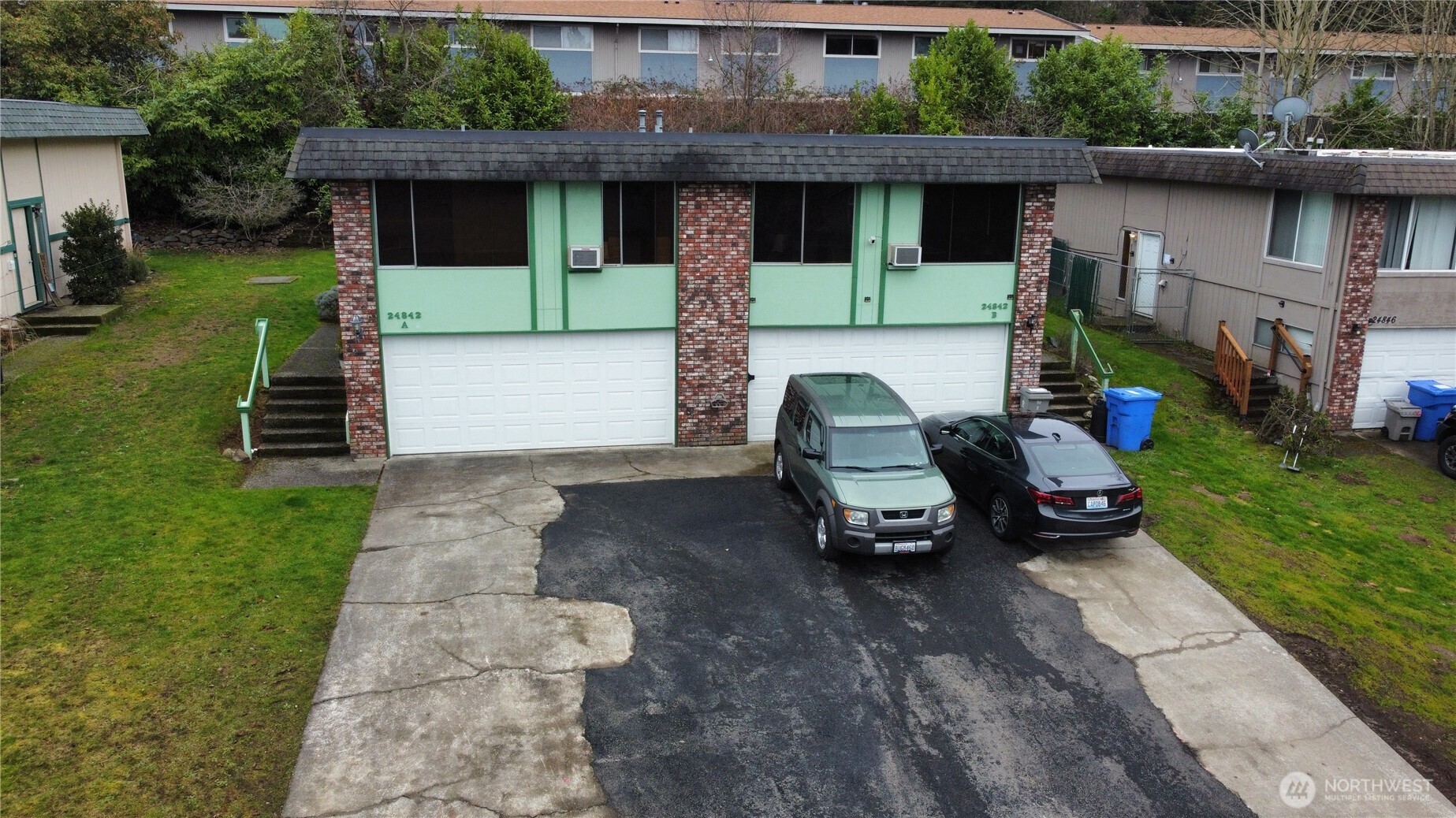 24842 96th Avenue South Kent, WA 98030 - Photo 2 of 7 a car parked in front of a house with a yard