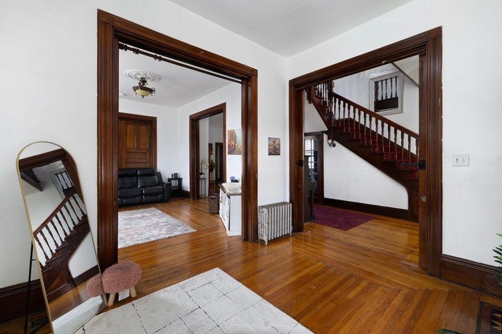 311 Elm Street Woonsocket, RI 02895 - Photo 13 of 29 a view of a hallway with wooden floor and staircase
