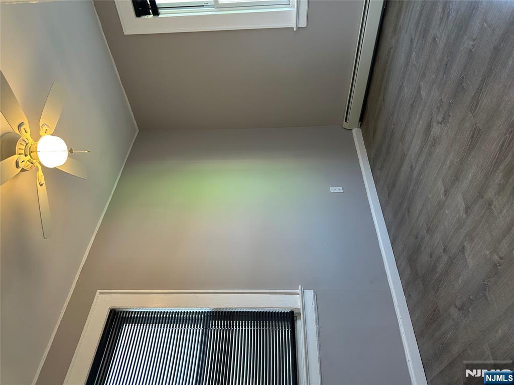 1041 Hunterdon Street Newark, NJ 07112 - Photo 12 of 25 wooden floor in an empty room with a window