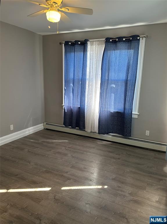1041 Hunterdon Street Newark, NJ 07112 - Photo 13 of 25 an empty room with wooden floor and window
