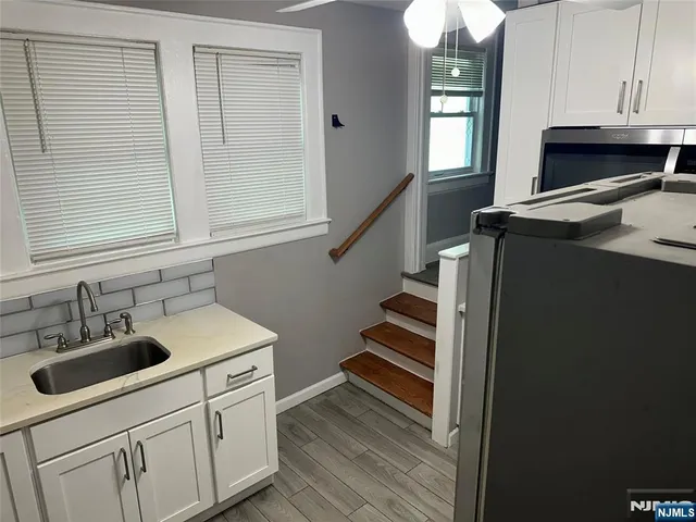 a kitchen with sink cabinets and appliances