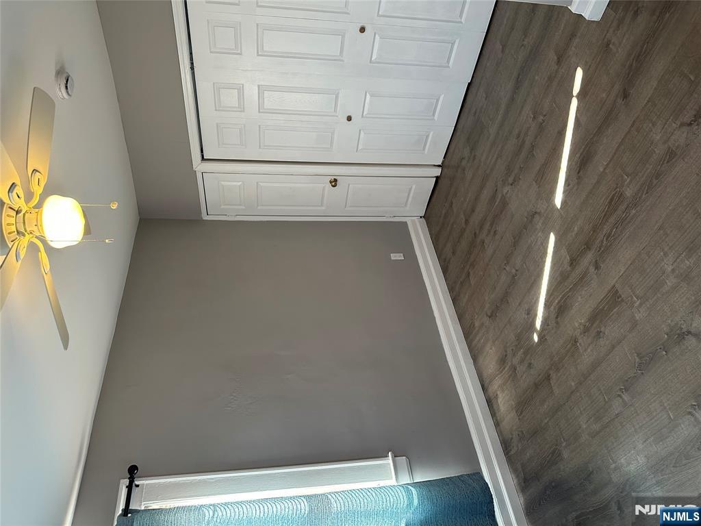 1041 Hunterdon Street Newark, NJ 07112 - Photo 9 of 25 an empty room with wooden floor and windows