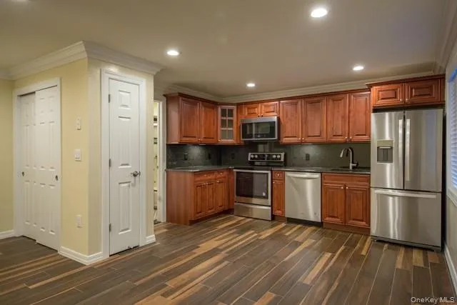 a kitchen with stainless steel appliances granite countertop a refrigerator and a stove top oven