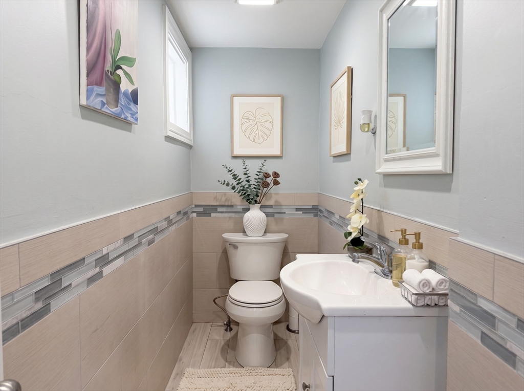 115 Hawthorn Road Braintree, MA 02184 - Photo 12 of 37 a bathroom with a sink mirror and toilet