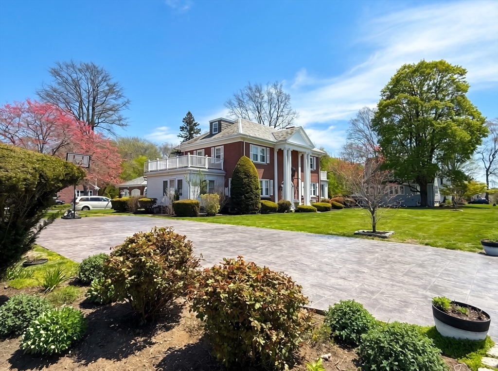 115 Hawthorn Road Braintree, MA 02184 - Photo 2 of 37 a front view of a house with a yard and potted plants