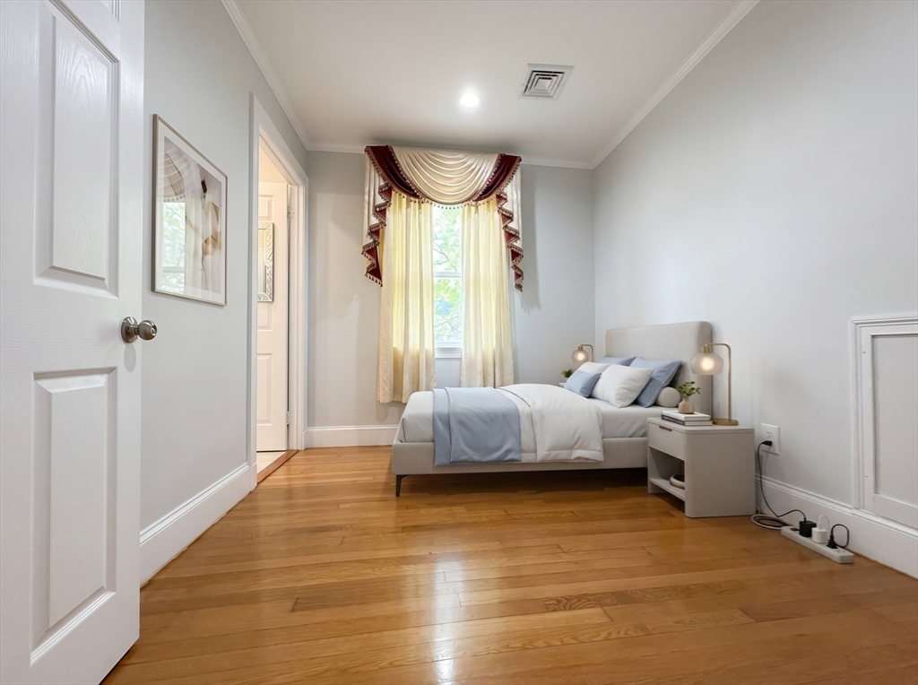 115 Hawthorn Road Braintree, MA 02184 - Photo 22 of 37 a spacious bedroom with a bed and a large window