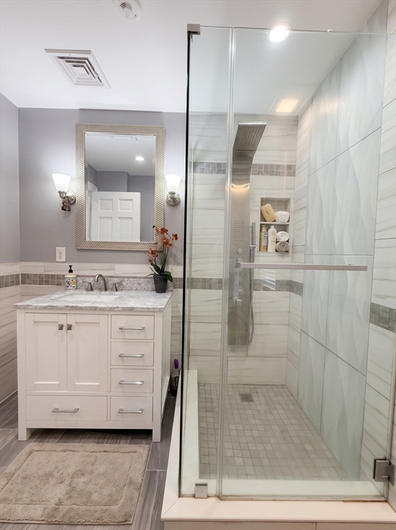 115 Hawthorn Road Braintree, MA 02184 - Photo 26 of 37 a bathroom with a double vanity sink a mirror and shower
