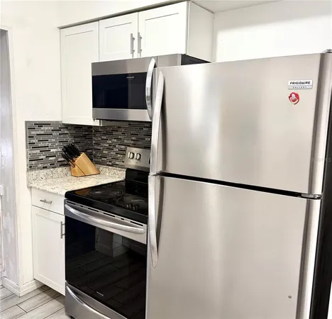a white refrigerator freezer sitting inside of a kitchen