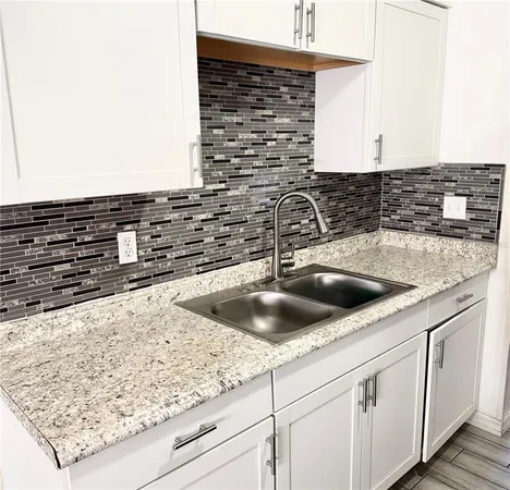 a kitchen with sink and cabinets