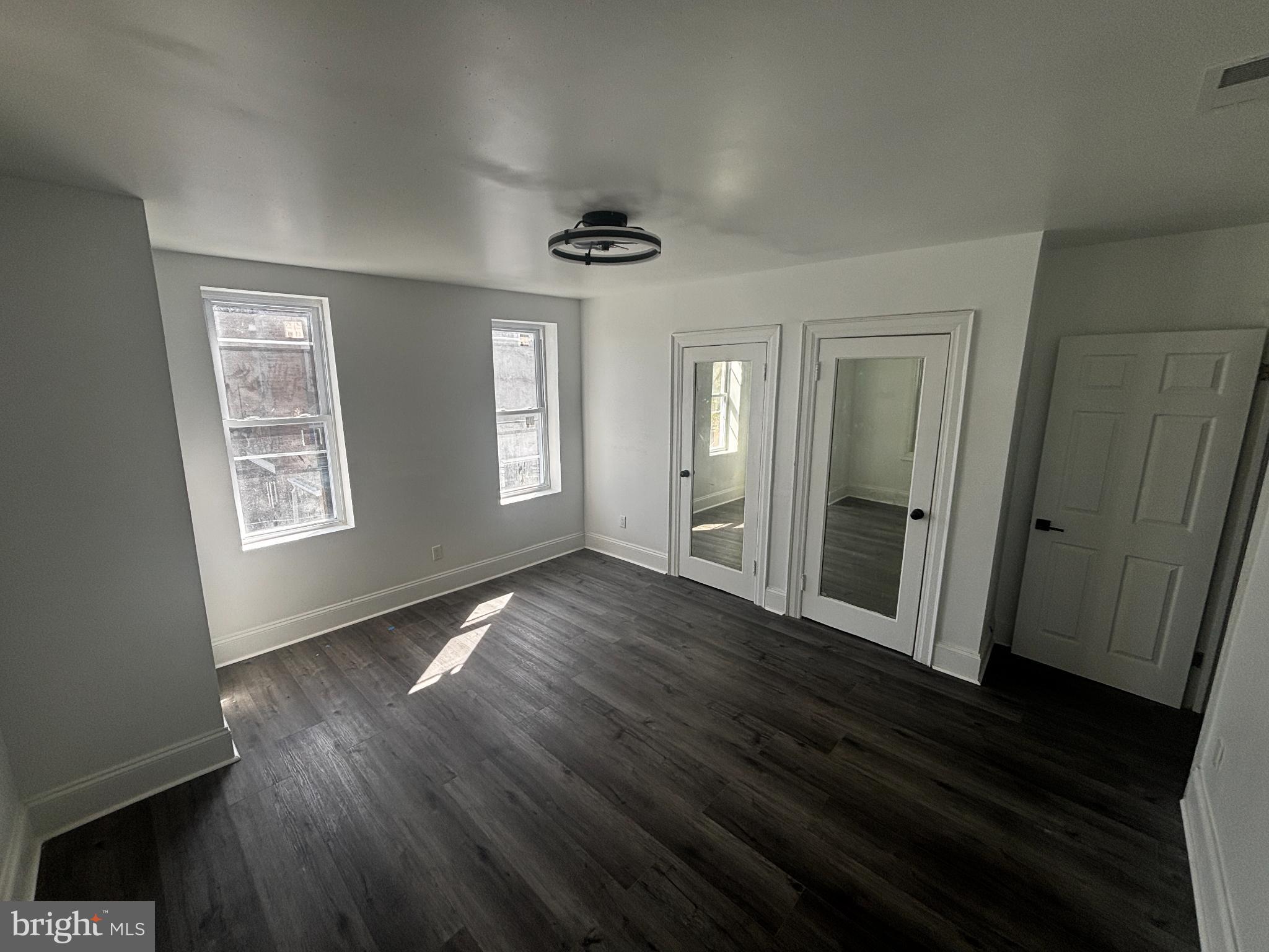 901 South 60th Street Philadelphia, PA 19143 - Photo 21 of 34 a view of an empty room with wooden floor and a window