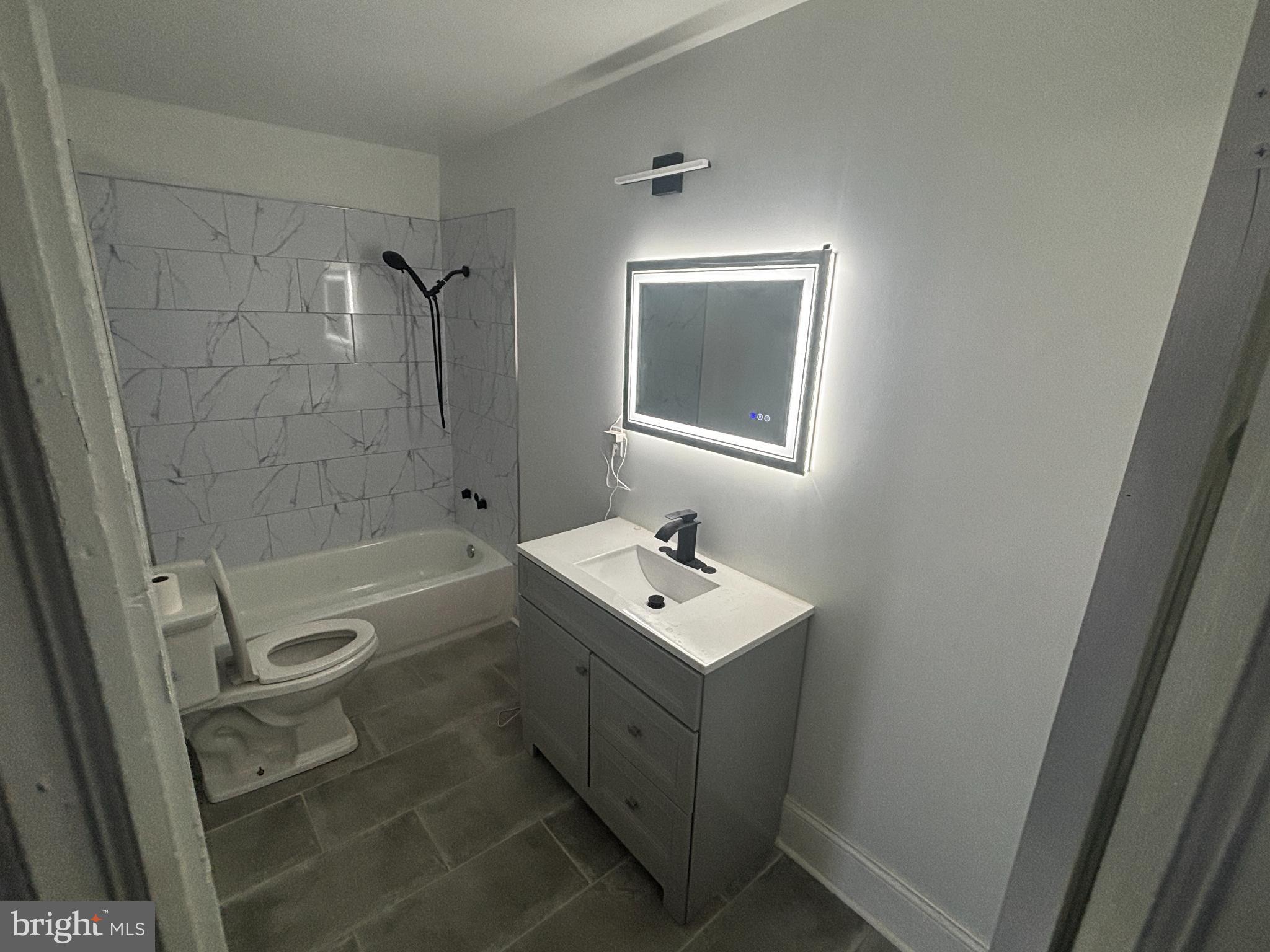901 South 60th Street Philadelphia, PA 19143 - Photo 27 of 34 a bathroom with a sink a toilet and shower