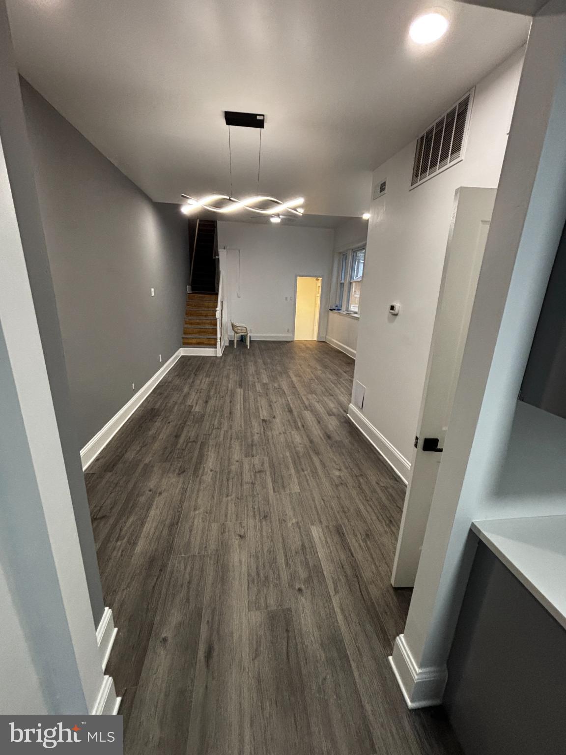 901 South 60th Street Philadelphia, PA 19143 - Photo 10 of 34 wooden floor in an empty room with a fireplace