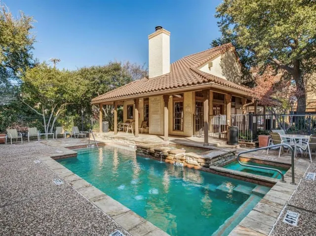 a view of a house with swimming pool and sitting area
