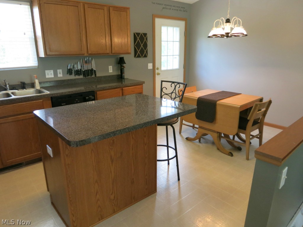 Open eat-in kitchen with island and breakfast bar - enough for 3 stools