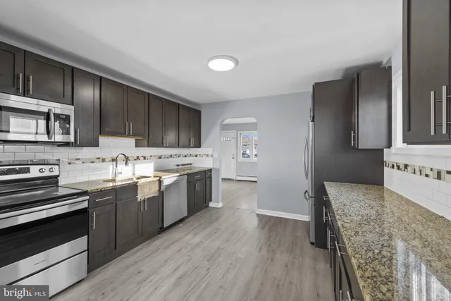 a kitchen with a sink stove and cabinets