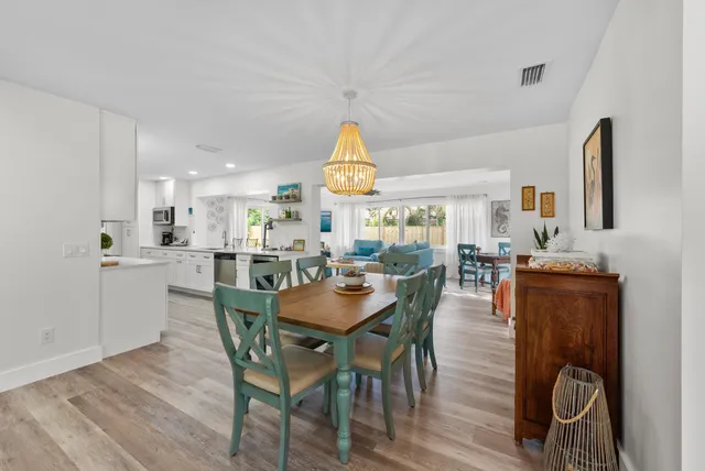a view of a dining room with furniture and a window