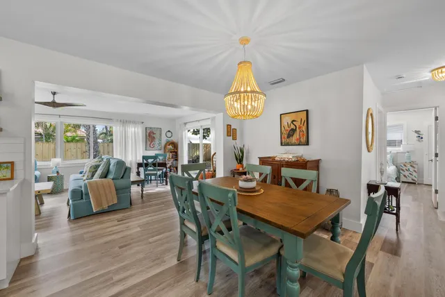 a living room with furniture and a view of kitchen