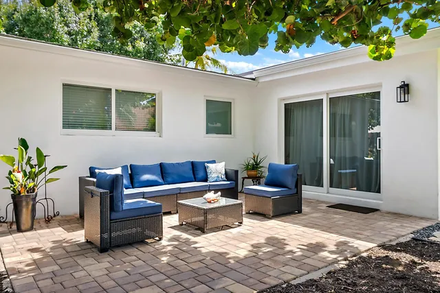 a view of a house with a yard and sitting area