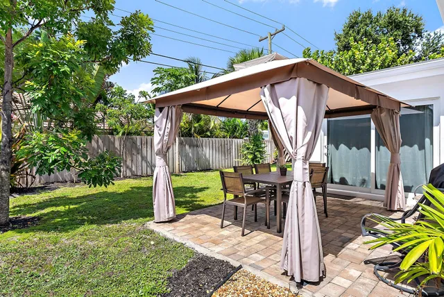 a view of table and chair with wooden fence