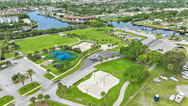 a view of a swimming pool with a lake view and trees in the background