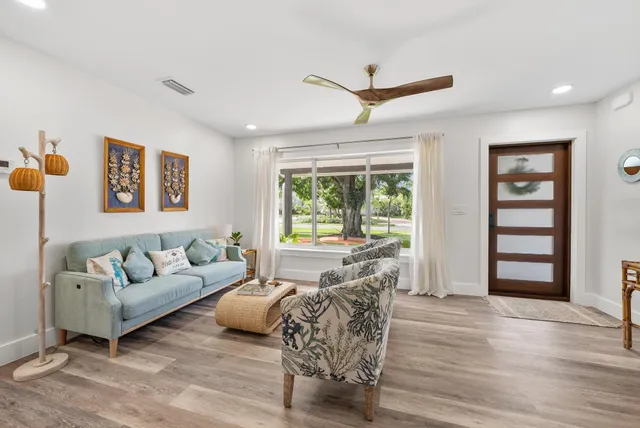 a living room with furniture and a large window