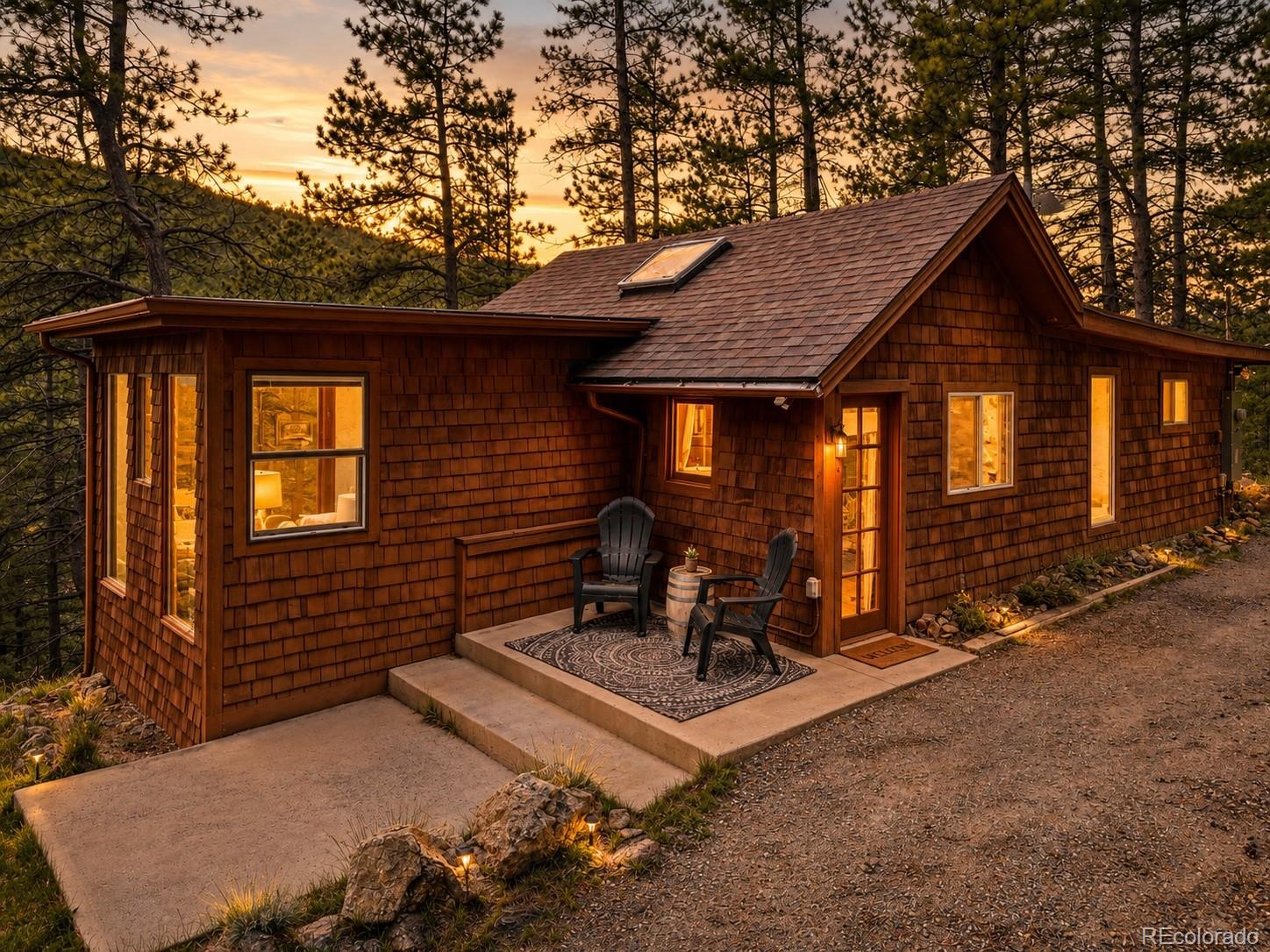 7520 South Blue Creek Road Evergreen, CO 80439 - Photo 2 of 22 a house view with a outdoor space