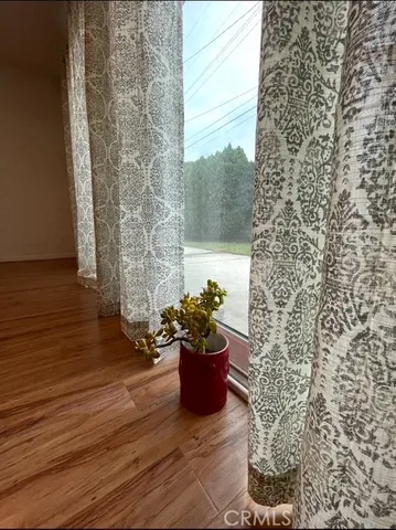 a view of empty room with kitchen and window