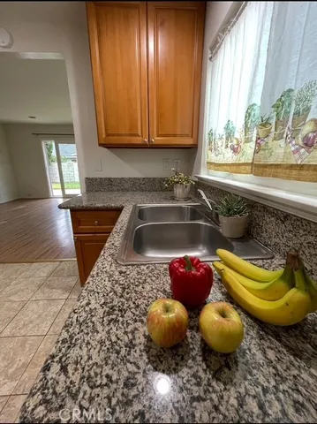 a kitchen with stainless steel appliances granite countertop a sink and stove top oven