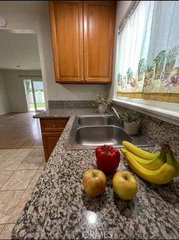 a kitchen with stainless steel appliances granite countertop a sink and stove top oven