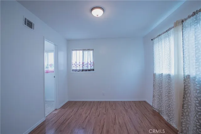 a view of room with hardwood floor and closet