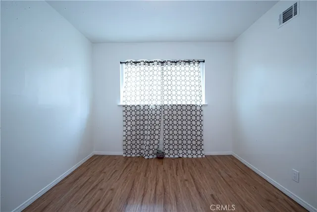 a view of a room with wooden floor and plant