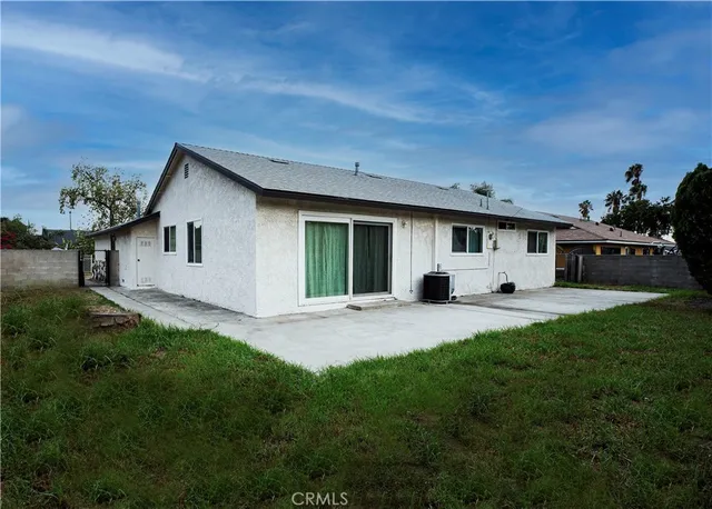 a front view of a house with a garden and yard