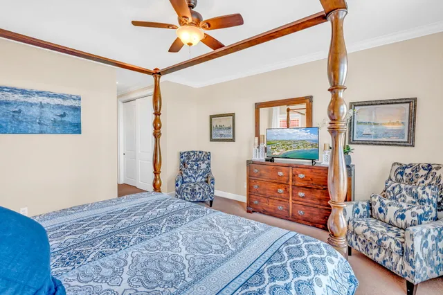 a bedroom with bed and wooden cabinets