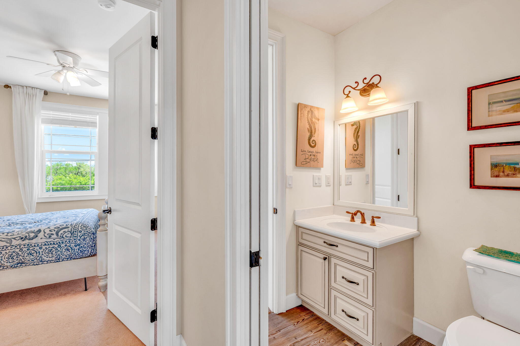 231 Sombrero Beach Road, Unit 1 Marathon, FL 33050 - Photo 19 of 52 a bathroom with a sink toilet vanity and window