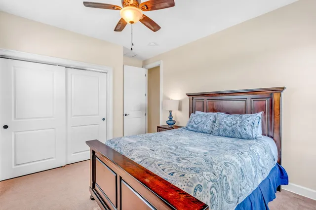 a bedroom with a large bed and a chandelier