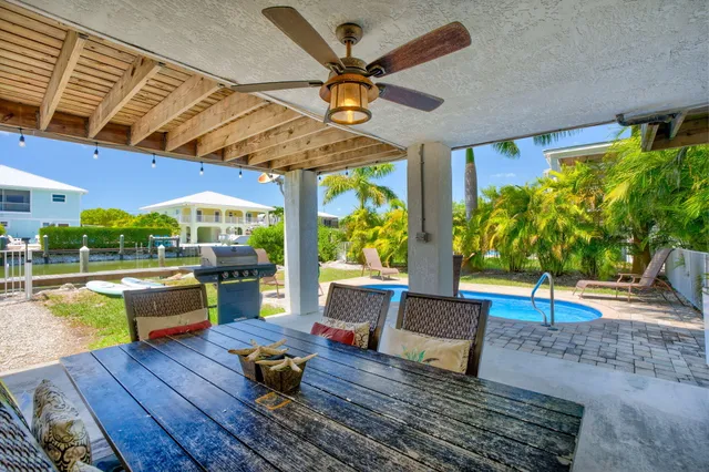 a living room with patio furniture and a wooden floor