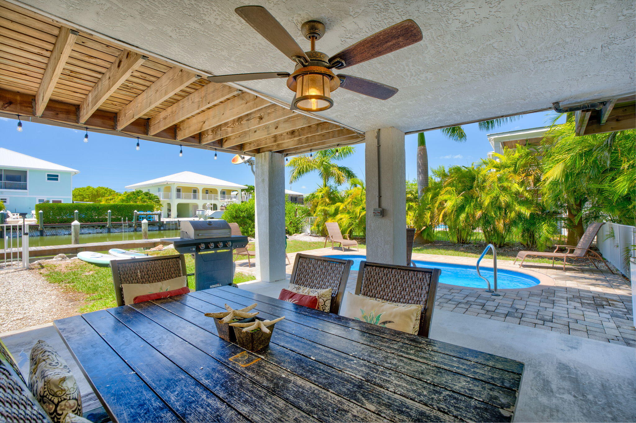 231 Sombrero Beach Road, Unit 1 Marathon, FL 33050 - Photo 28 of 52 a living room with patio furniture and a wooden floor
