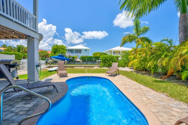 a view of a swimming pool with an outdoor seating