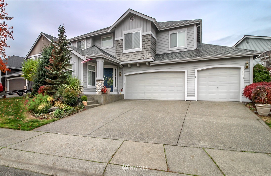 18547 173rd Way Southeast Renton, WA 98058 - Photo 1 of 27 a front view of a house with a yard and garage