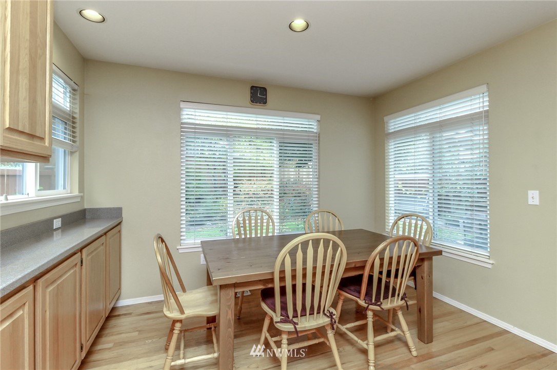 18547 173rd Way Southeast Renton, WA 98058 - Photo 13 of 27 a view of a dining room with furniture and windows