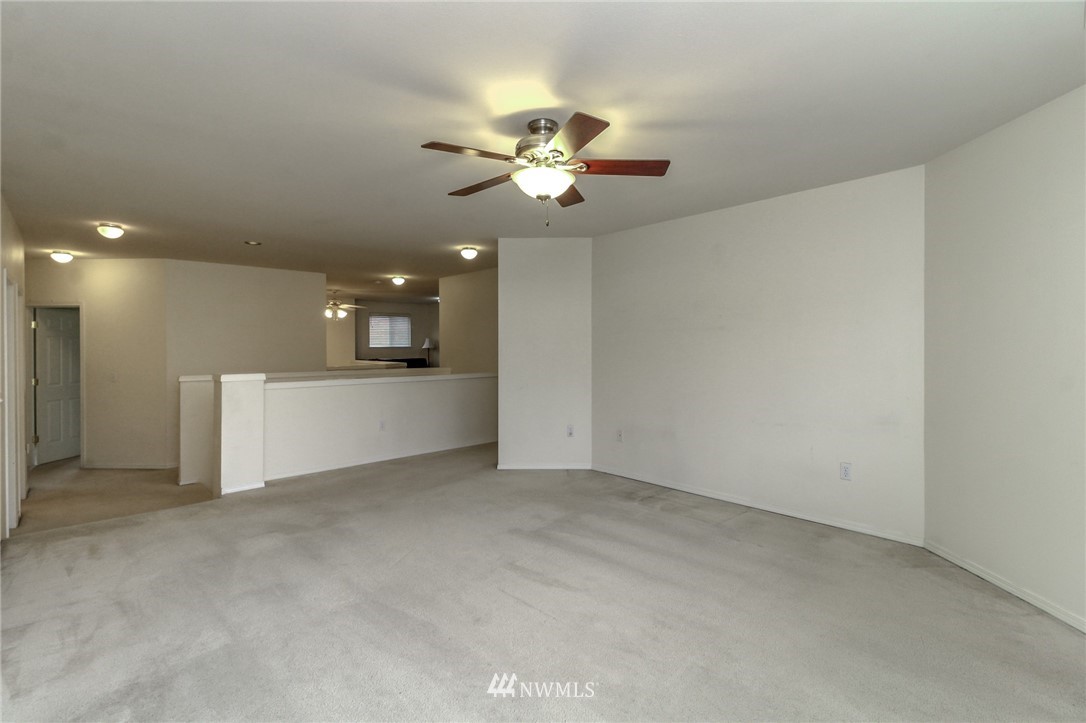 18547 173rd Way Southeast Renton, WA 98058 - Photo 16 of 27 a view of a kitchen with a ceiling fan and a projector