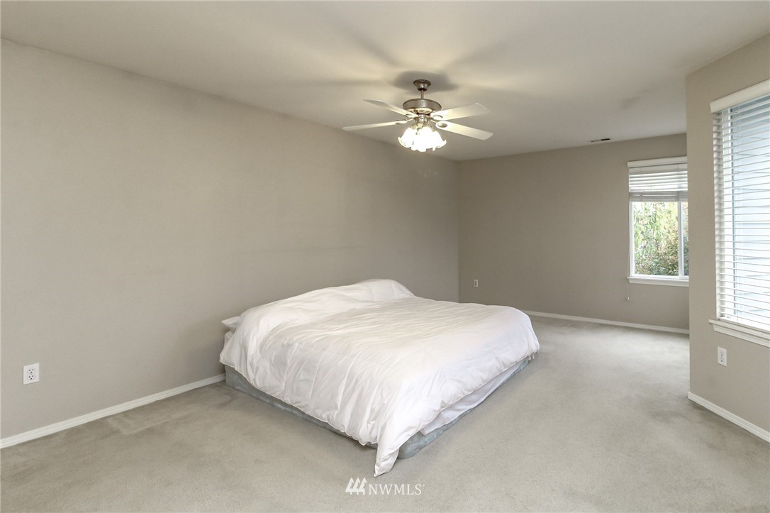 18547 173rd Way Southeast Renton, WA 98058 - Photo 17 of 27 a bed sitting in a bedroom next to a window