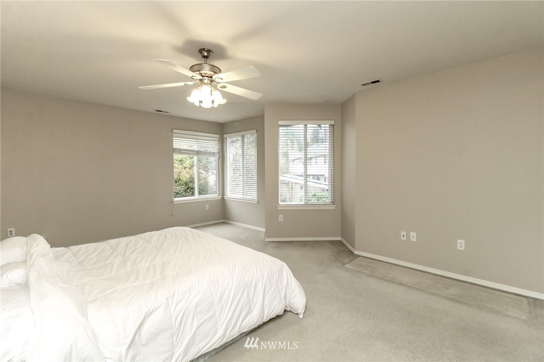 18547 173rd Way Southeast Renton, WA 98058 - Photo 18 of 27 a bedroom with a large bed and a window