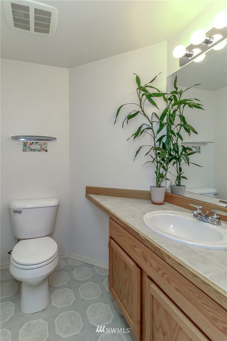 18547 173rd Way Southeast Renton, WA 98058 - Photo 7 of 27 a bathroom with a toilet a sink and mirror