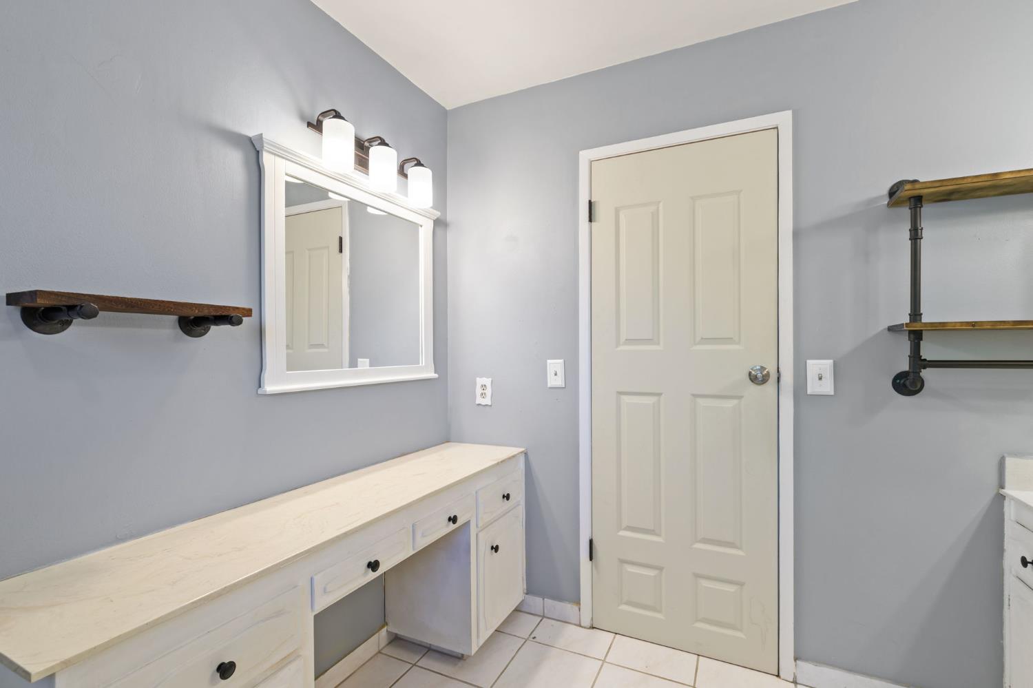 2012 Beverly Avenue Clovis, CA 93611 - Photo 11 of 42 a bathroom with a shower sink and mirror