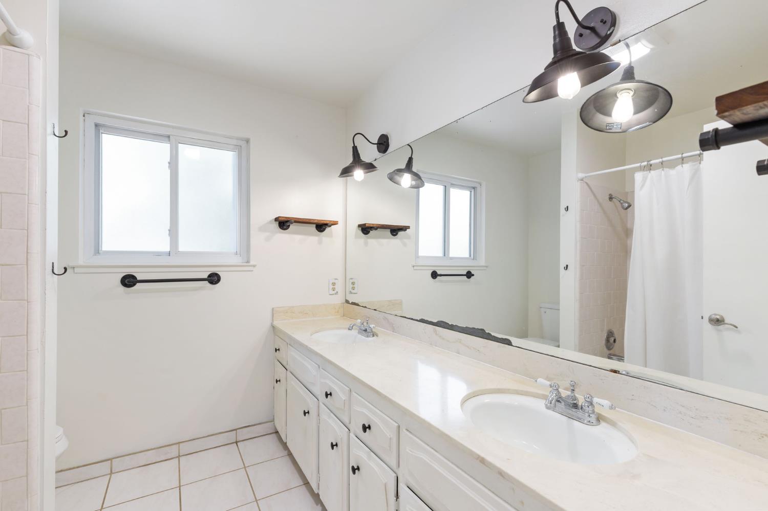 2012 Beverly Avenue Clovis, CA 93611 - Photo 13 of 42 a bathroom with a double vanity sink mirror and double