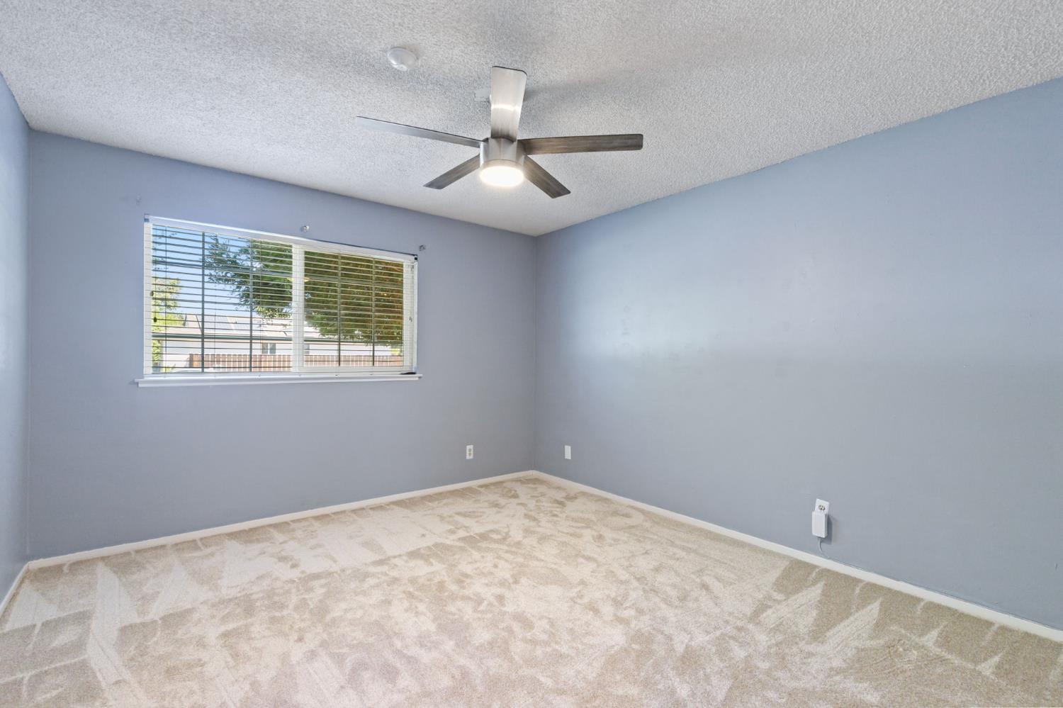 2012 Beverly Avenue Clovis, CA 93611 - Photo 14 of 42 an empty room with windows and fan